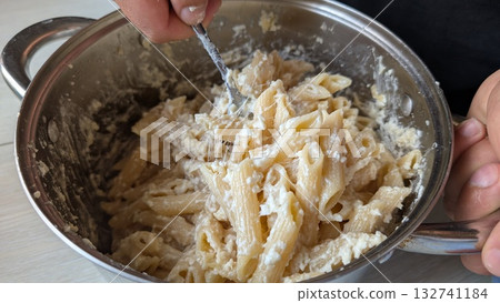 A Creamy Pasta Dish Expertly Mixed to Perfection in the Kitchen, Truly Scrumptious A Creamy Pasta Dish Expertly Mixed to Perfection in the Kitchen, Truly Scrumptious 132741184