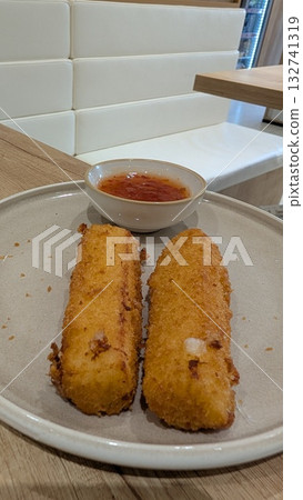A Delicious Presentation of Fried Snacks Accompanied by a Tasty Dipping Sauce Delight 132741319