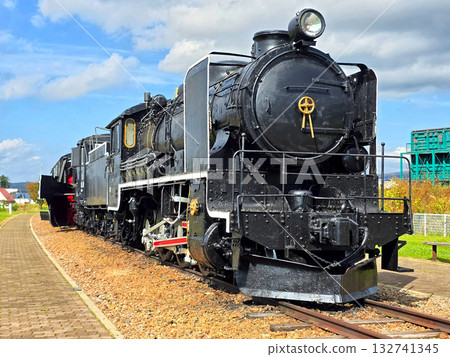 Black metal steam train and rail track in the outdoor history museum 132741345