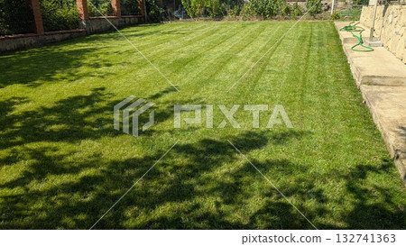 A Beautiful Lush Green Lawn with Freshly Cut Grass Patterns That Captivate the Eye and Spirit A Beautiful Lush Green Lawn with Freshly Cut Grass Patterns That Captivate the Eye and Spirit 132741363