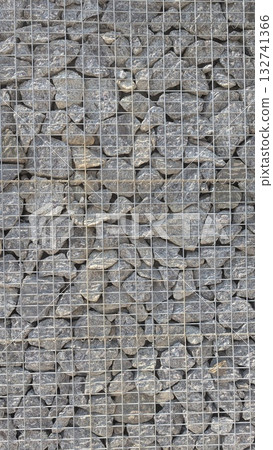 A beautifully crafted Textured Gabion Wall made of various aggregates for visual appeal 132741366