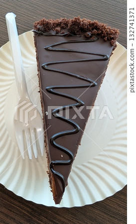 A mouthwatering and Delicious Slice of Chocolate Cake Placed Elegantly on a Plate A mouthwatering and Delicious Slice of Chocolate Cake Placed Elegantly on a Plate 132741371
