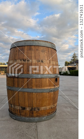 A rustic wooden barrel in a serene outdoor setting captures attention and evokes nostalgia 132741631