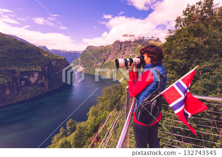 Tourist taking photo of fjord landscape, Norway 132743545