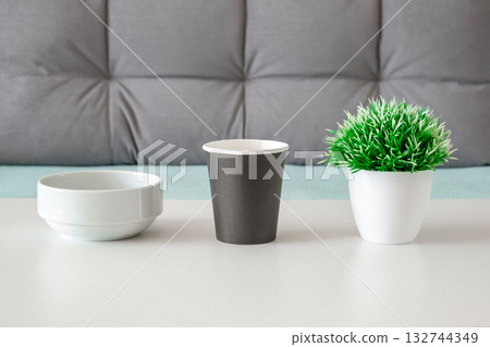 bowl paper cup and decorative flower on table bowl paper cup and decorative flower on table 132744349