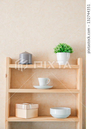 candle, decorative flower, mug, bowl, gift box on shelves candle, decorative flower, mug, bowl, gift box on shelves 132744351