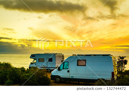 Camper vehicles on beach at sunrise Camper vehicles on beach at sunrise 132744472