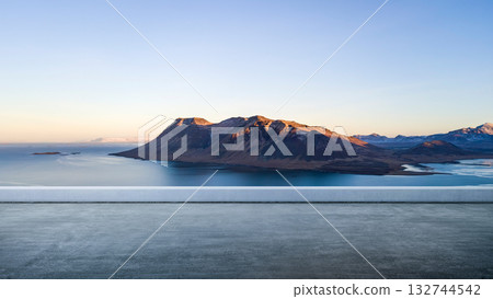 Concrete platform with a landscape of a mountain range with a calm ocean on a blue sky background. Natural background Concrete platform with a landscape of a mountain range with a calm ocean on a blue sky background. Natural background 132744542