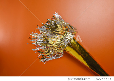 Party horn on a red background. Concept of a party or a holiday celebration 132744583