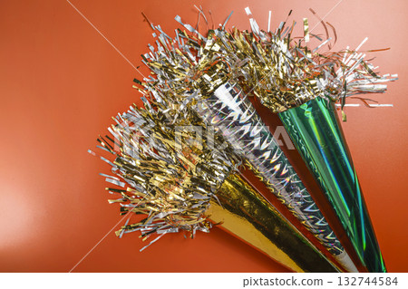 Party horn on a red background. Concept of a party or a holiday celebration Party horn on a red background. Concept of a party or a holiday celebration 132744584