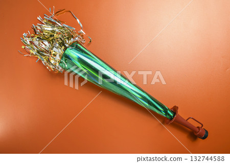 Party horn on a red background. Concept of a party or a holiday celebration Party horn on a red background. Concept of a party or a holiday celebration 132744588
