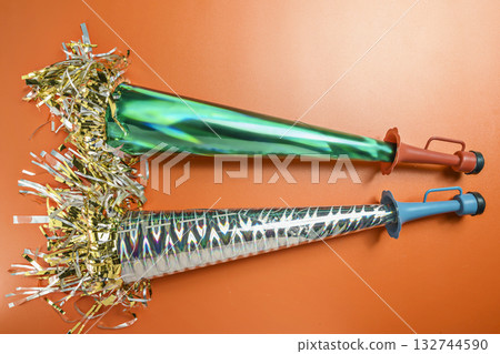 Party horn on a red background. Concept of a party or a holiday celebration Party horn on a red background. Concept of a party or a holiday celebration 132744590