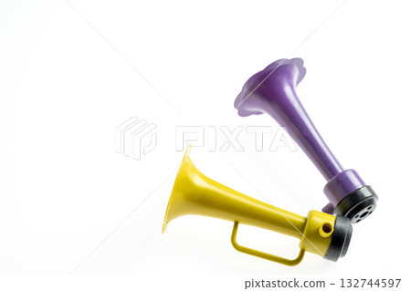 Plastic horn isolated over a white background. Concept of a party or a holiday celebration Plastic horn isolated over a white background. Concept of a party or a holiday celebration 132744597