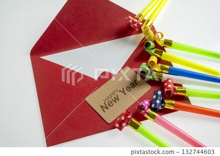 Red envelope with a greeting card of Happy New Year with party blowers. Mockup or Copy space. Happy New Year concept or Celebration 132744603