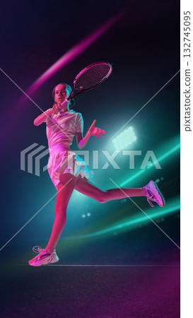 Female tennis player striking forehand under neon lights with focus and emotion Female tennis player striking forehand under neon lights with focus and emotion 132745095