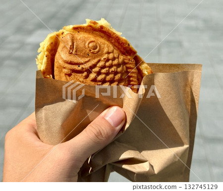 Taiyaki eaten outdoors Taiyaki eaten outdoors 132745129