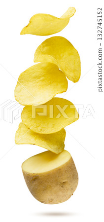 Potato chips flying out of a raw potato on a white background. Isolated 132745152