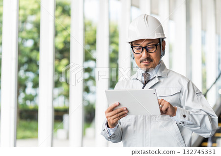 Working clothes men who operate tablets 132745331