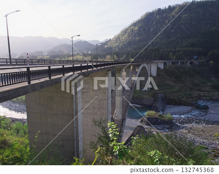 Tateyama Bridge spanning the fresh green Joganji River 132745368