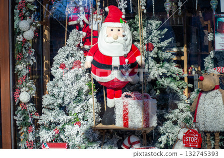 Beautiful Christmas decorations sparkling with festive colors in a cozy shop in Spisska Nova Ves, Slovakia. 132745393