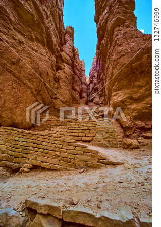 Stone Switchback Trail Between Red Canyon Walls on Navajo Loop in Sunlight Stone Switchback Trail Between Red Canyon Walls on Navajo Loop in Sunlight 132746999