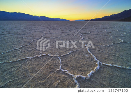 Salt Flats Pattern and Mountain Silhouette at Golden Hour in Remote Desert Landscape Salt Flats Pattern and Mountain Silhouette at Golden Hour in Remote Desert Landscape 132747190