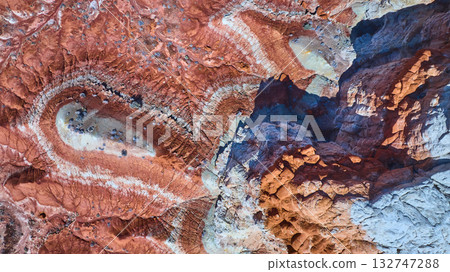Aerial Red and Orange Striated Desert Rocks with Swirling Patterns and Cliffs Aerial Red and Orange Striated Desert Rocks with Swirling Patterns and Cliffs 132747288