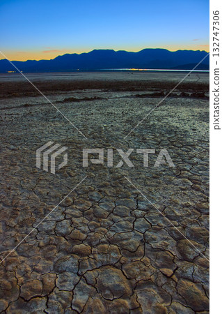 Cracked Earth and Mountains at Golden Hour on Boulder City Dry Lake Bed 132747306