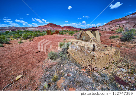 Abandoned Concrete Ruins in Red Desert Landscape with Mesas and Blue Sky Utah 132747399