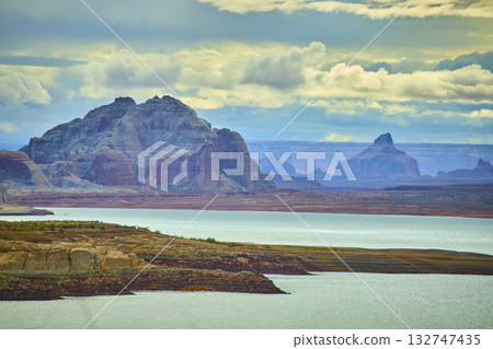 Lake Powell Sandstone Cliffs and Calm Water with Dramatic Cloudy Sky 132747435