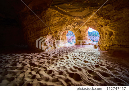 Sunlit Sandstone Arches and Rippling Sand Floor in Kanab Utah Cave at Golden Hour Sunlit Sandstone Arches and Rippling Sand Floor in Kanab Utah Cave at Golden Hour 132747437