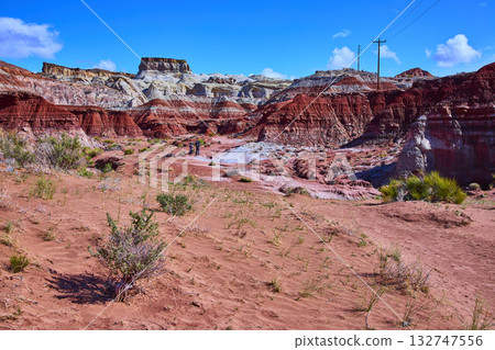 Painted Desert Buttes and Hikers Under Blue Sky in Arizona Wilderness Painted Desert Buttes and Hikers Under Blue Sky in Arizona Wilderness 132747556
