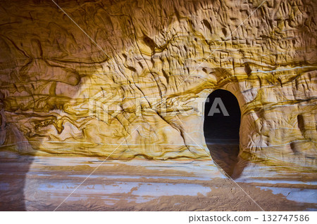 Sandstone Cave Entrance with Swirling Patterns at Golden Hour Utah 132747586