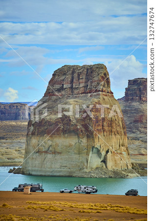 Lone Rock Sandstone Formation and RV Camping by Lake Powell under Blue Sky Lone Rock Sandstone Formation and RV Camping by Lake Powell under Blue Sky 132747674