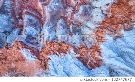 Aerial Colorful Sedimentary Rock Layers and Swirling Desert Patterns Top Down 132747677
