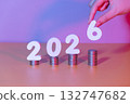 2026 New year saving money and financial planning concept. Female hands putting white number 2026 on stack of coins. Creative idea for business growth, tax payment, investment and banking. 132747682