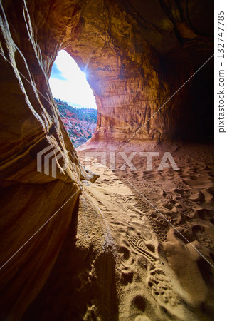 Sandstone Cave Interior with Sunlit Entrance and Footprints Kanab Utah Sandstone Cave Interior with Sunlit Entrance and Footprints Kanab Utah 132747785