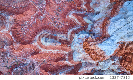 Aerial Painted Desert Swirling Red Rock Patterns and Eroded Buttes 132747813