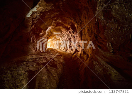Sandstone Tunnel Interior with Sunlit Exit and Carved Walls Kanab Utah Sandstone Tunnel Interior with Sunlit Exit and Carved Walls Kanab Utah 132747821
