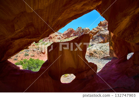 Arch Formation Framing Red Rock Desert Landscape and Blue Sky Arch Formation Framing Red Rock Desert Landscape and Blue Sky 132747903