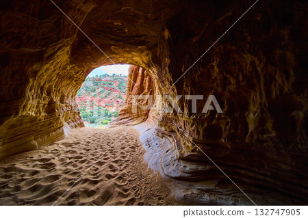 Sandstone Cave Interior with Footprints and Sunlit Red Rock Desert Utah Sandstone Cave Interior with Footprints and Sunlit Red Rock Desert Utah 132747905