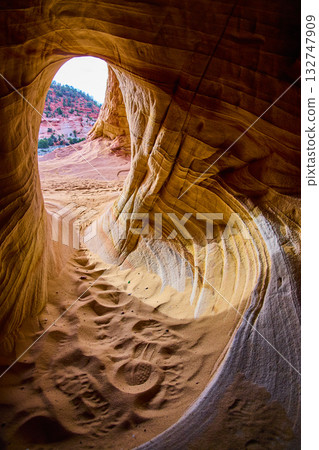 Sandstone Cave Interior with Footprints and Sunlit Desert Beyond Kanab Utah Sandstone Cave Interior with Footprints and Sunlit Desert Beyond Kanab Utah 132747909
