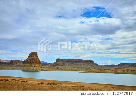 Lone Rock and Desert Shoreline at Lake Powell with Dramatic Sky 132747917