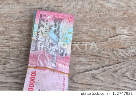 indonesia rupiah banknote arranging on wooden table texture and background them indonesia rupiah banknote arranging on wooden table texture and background them 132747921