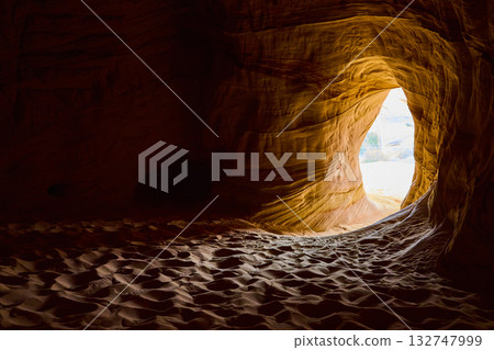 Sandstone Cave Interior with Sunlit Entrance and Rippling Sand Floor Sandstone Cave Interior with Sunlit Entrance and Rippling Sand Floor 132747999