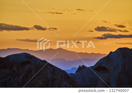 Sunset Layers Over Desert Rock Formations and Mountains in Golden Hour Light Sunset Layers Over Desert Rock Formations and Mountains in Golden Hour Light 132748007