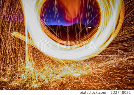 Steel Wool Sparks Swirling Over Desert Ground at Golden Hour in Nevada 132748021