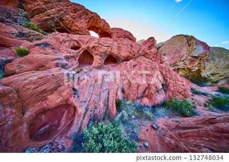Red Rock Arch Formation and Desert Vegetation Under Blue Sky Red Rock Arch Formation and Desert Vegetation Under Blue Sky 132748034