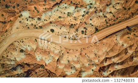 Aerial Top Down Desert Road Winding Through Colorful Rock Formations Utah Aerial Top Down Desert Road Winding Through Colorful Rock Formations Utah 132748035