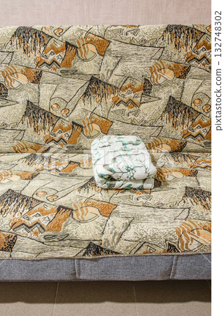 folded blanket is lying on couch folded blanket is lying on couch 132748302